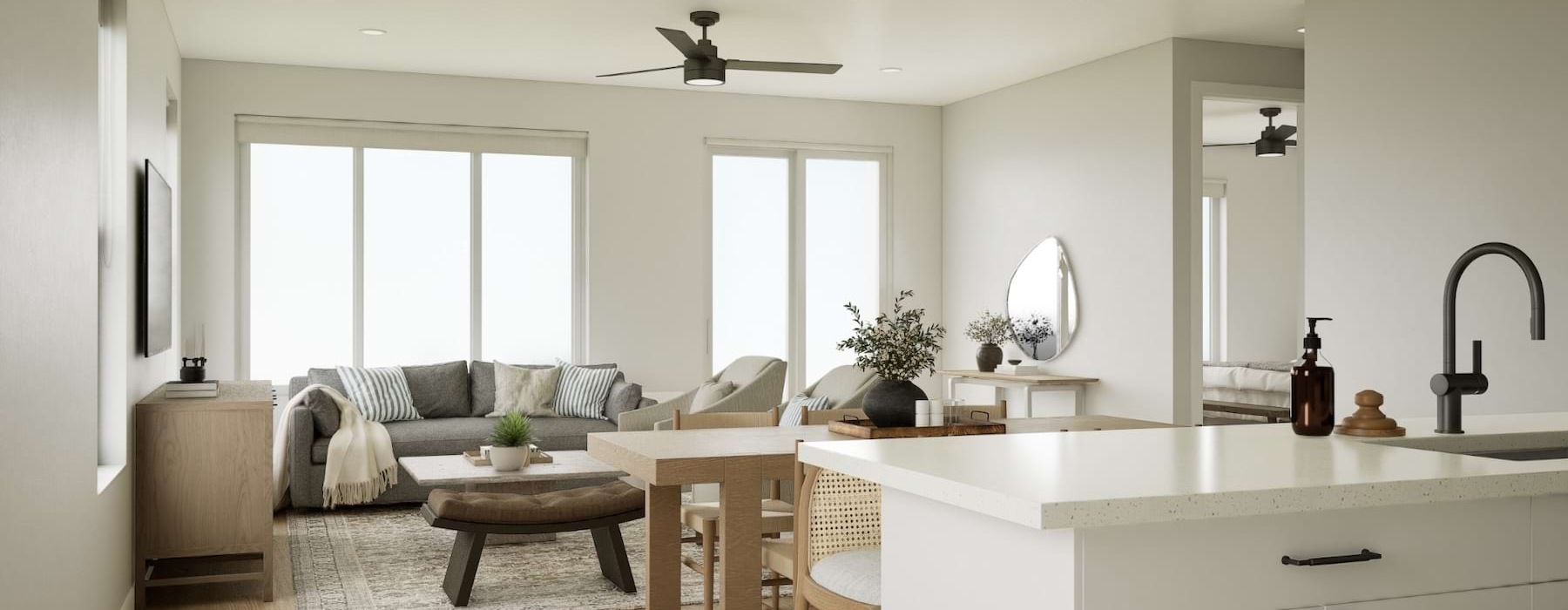 a kitchen and a living room with a couch and tables
