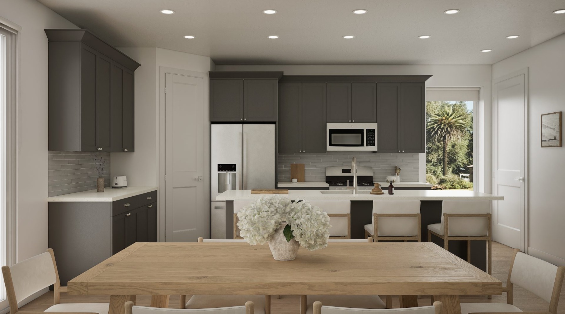 a kitchen with a dining table and chairs